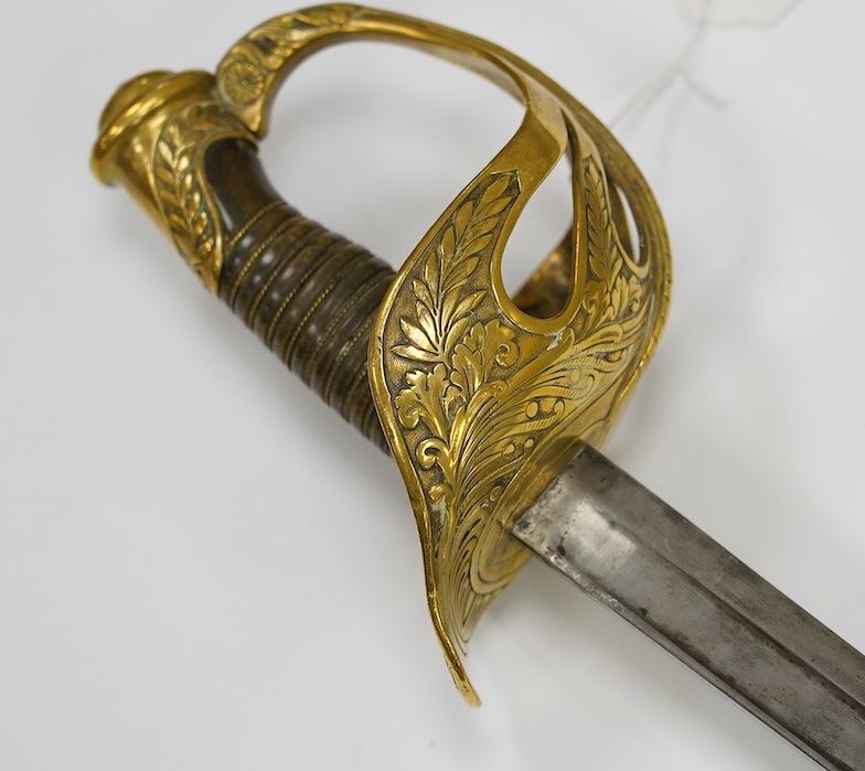 A French 1890 Cuirassier’s sword, brass boat shaped guard with foliage in relief, wirebound horn grip 'Medusa's Head Motif' to thumb scroll, blade 92.5cm. Condition - good